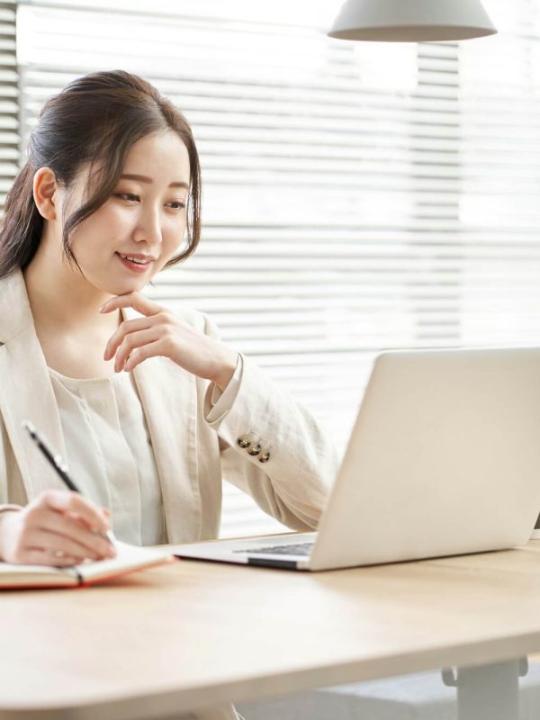 asian-woman-taking-notes-in-a-coworking-space.jpg